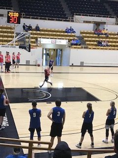 One of the players doing a lay up on the fun games before the basketball game.