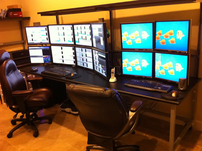 Hexatruple monitor setup next to a quadruple monitor setup.