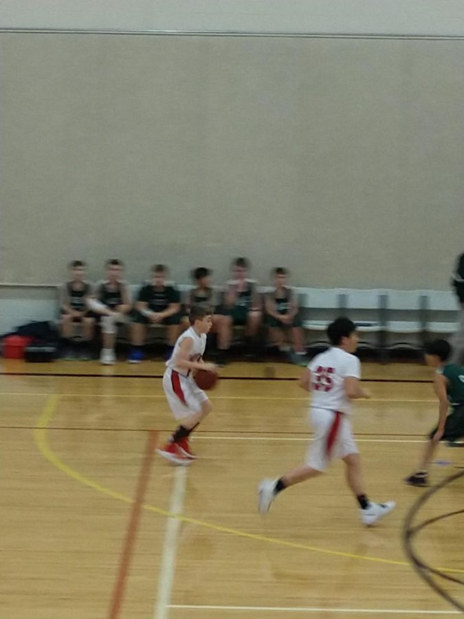 This is Emporia Middle School basketball player Braden Ary dribbling down the court.