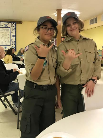 Female scouts of troop 157 serve their community with a hearty breakfast.