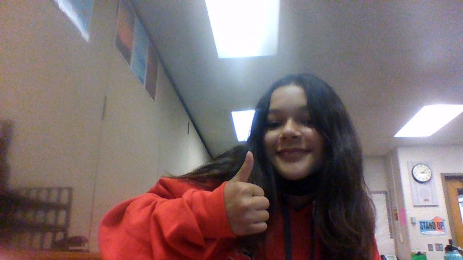 This is a picture of Mariah Vega, she is currently holding a thumbs up.