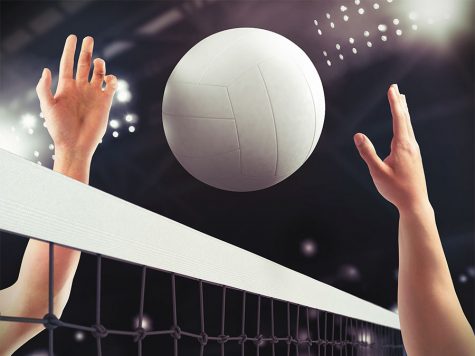 A volleyball flying over the net.
