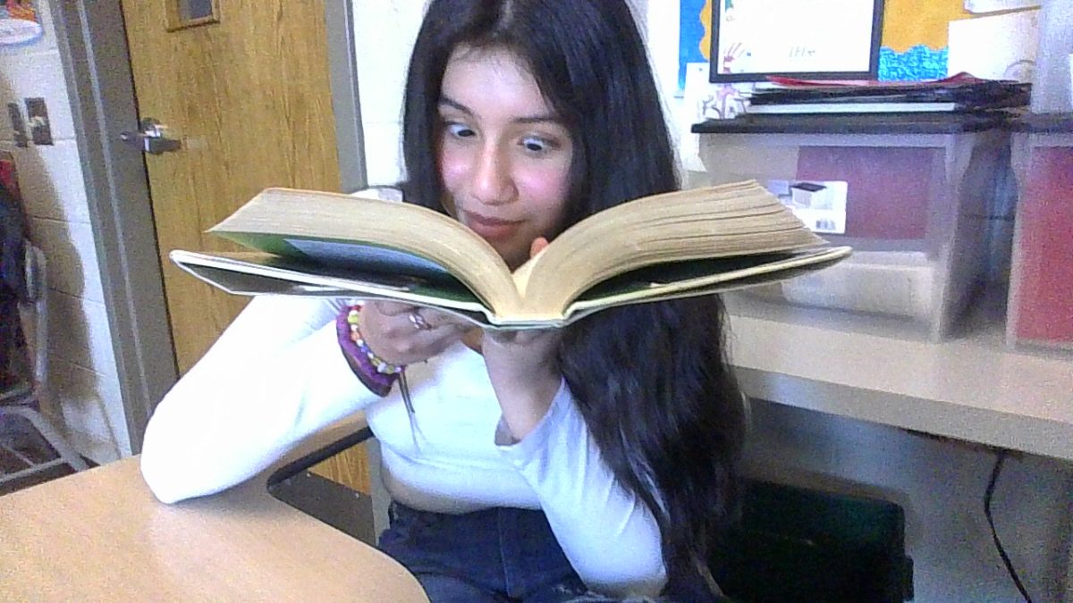 Julena Zamora speed-reading through her book to reach her goal of 5,000 minutes read.