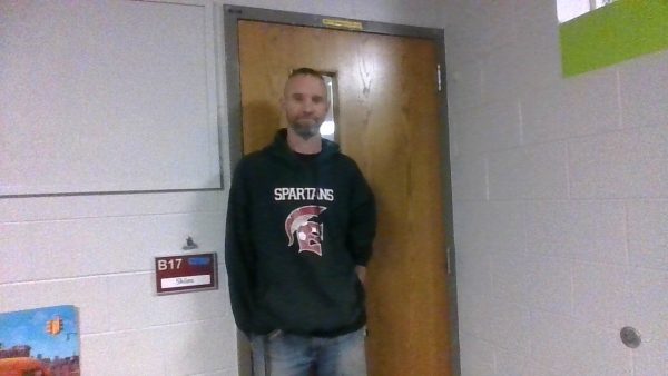 Mr. Skiles in front of his classroom.