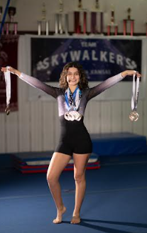 Me at practice with my medals in my competition leotard 